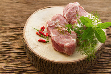 Raw pork on cutting board and vegetables