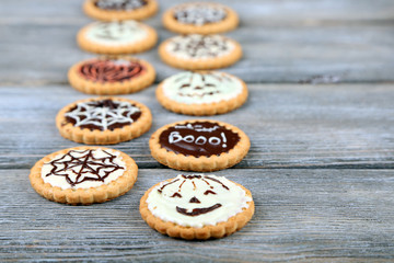 Tasty Halloween cookies on wooden table