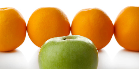 Juicy oranges and apple, close-up