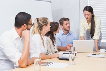 Business people listening a woman doing a presentation