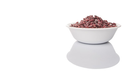 Red kidney beans in white bowl over white background