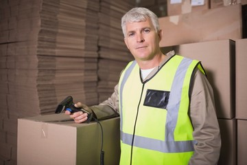 Worker scanning package in warehouse
