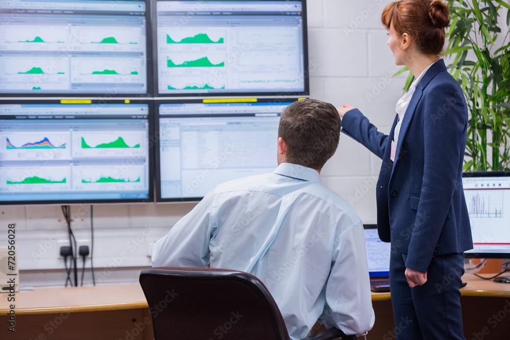 Poster focused colleagues analyzing result on their computer