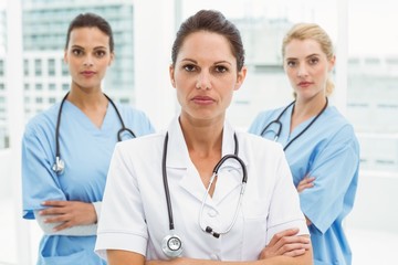 Portrait of confident female doctors with arms crossed