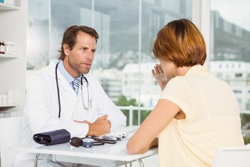 Fototapeta premium Doctor in discussion with patient at medical office