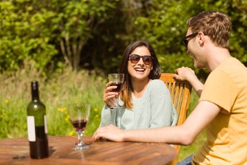 Young couple enjoying red wine