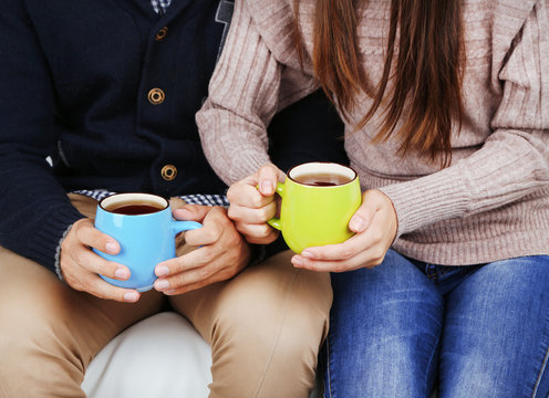 Loving couple with hot drinks