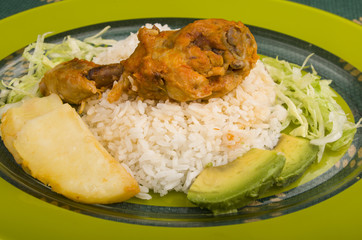 chicken served with white rice potato on a plate