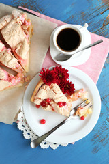 Piece of tasty pie with apples and berry mousse and cup of