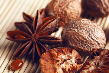Stars anise with nutmeg on wicker background