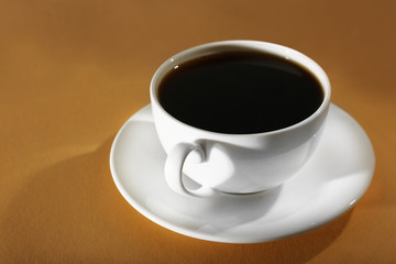 Obraz na płótnie Canvas Cup of coffee on beige background