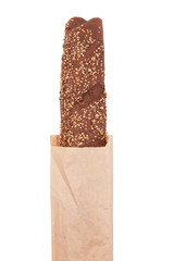 long loaf in paper bag, isolated on white background