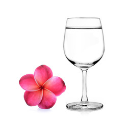 Glass of water and frangipani flower isolated white background