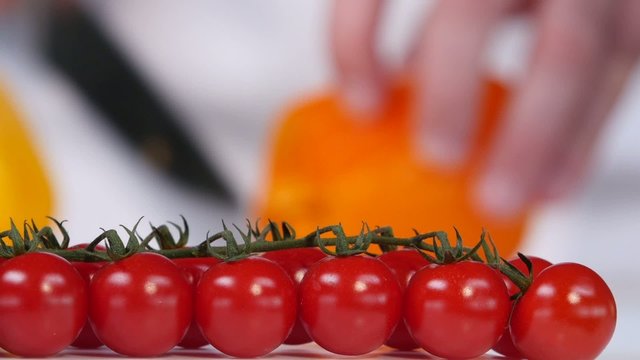 Cherry tomatoes on a background of yellow sweet pepper