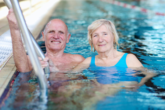 Healthy senior couple swimming in the pool