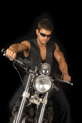 Fototapeta na wymiar man on motorcycle black vest dark glasses