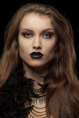 Closeup portrait of a gothic femme fatale with black lips