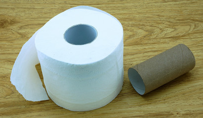 Roll of toilet paper on wooden floor