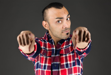 model isolated on plain background fingers pointing to camera