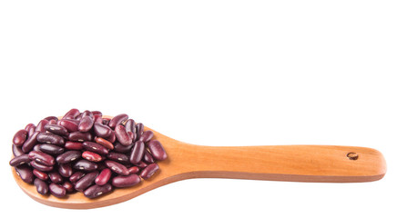 Red kidney beans on wooden spoon over white background
