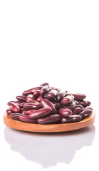Red kidney beans on wooden spoon over white background