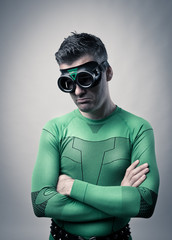 Pensive superhero with arms folded