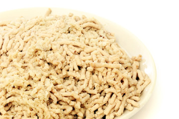 Minced meat from chicken on a plate isolated on white