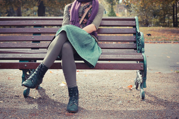 Young woman sitting on a park bench