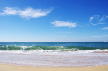 Fototapeta na wymiar Blue wave on the beach at Portugal