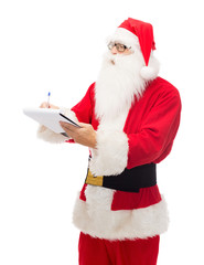 man in costume of santa claus with notepad