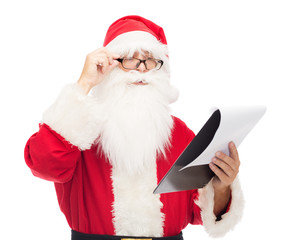 man in costume of santa claus with notepad