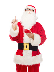 man in costume of santa claus with notepad