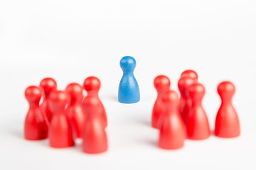 Center of attention blue pawn surrounded  by red pawns