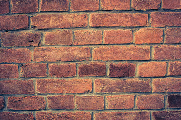 Weathered red brick wall background with vignette eccet, grungy