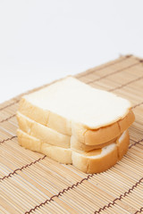 Sliced ​​bread on the wooden plate.