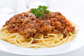 spaghetti bolognese on a white plate, close-up