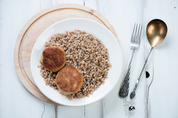 Boiled buckwheat with cutlets, horizontal shot, above view