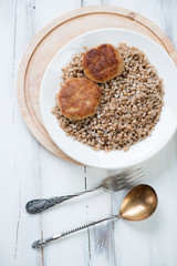 Meat cutlets and boiled buckwheat, vertical shot, above view
