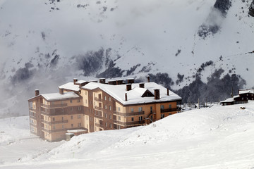 Hotel and ski slope at fog day