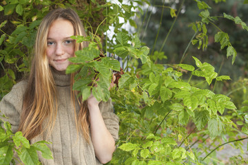 Cute young long-haired girl outdoor in the park.