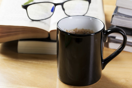 black coffee cup and book pile
