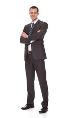 Confident Young Businessman Standing Arms Crossed