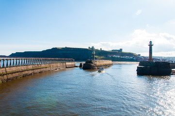 Scenic view of Whitby Pier in sunny day in North Yorkshire, UK.