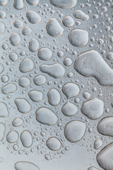 Metal surface covered in water drops.