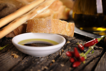 Small bowl of olive oil and balsamic vinegar with dipping bread