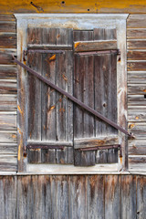 Closed window in a wooden house