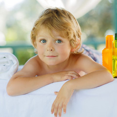 Adorable little blond kid relaxing in spa with having massage © Irina Schmidt