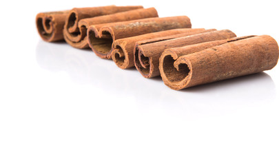 Cinnamon sticks over white background