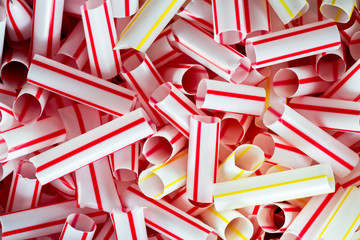 Plastic drinking straws cut into pieces close up.