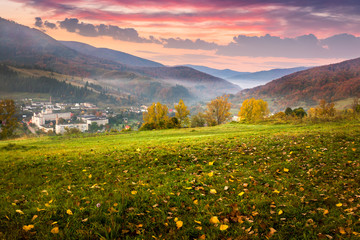 village on hillside meadow with foliage in mountain at sunrise - Powered by Adobe